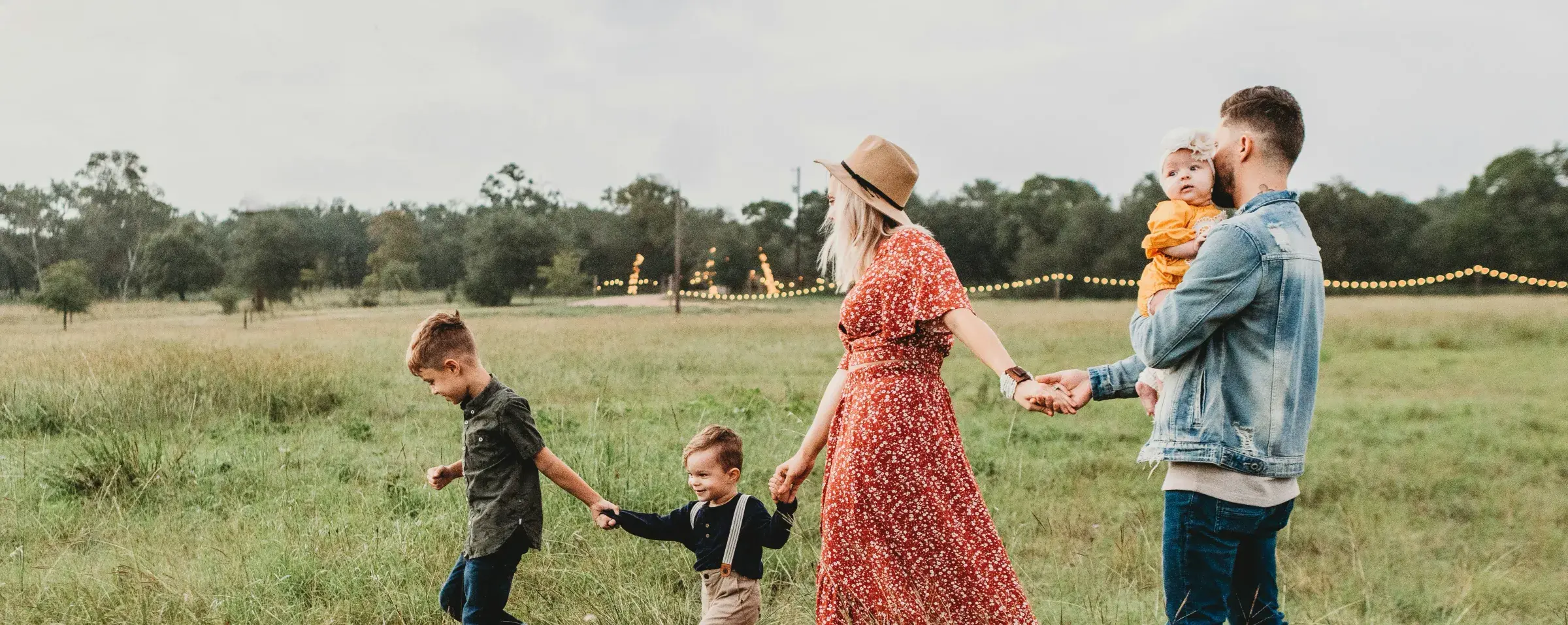 People walking through a sunny field